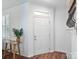 Bright entryway with hardwood floors, white walls, and decorative accents at 2656 Polo Club Blvd, Matthews, NC 28105