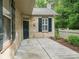 Charming front entrance with stone facade, black door, and decorative shutters at 2656 Polo Club Blvd, Matthews, NC 28105