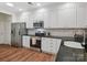 Bright kitchen featuring white cabinets, granite countertops, stainless steel appliances and a subway tile backsplash at 2656 Polo Club Blvd, Matthews, NC 28105