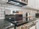 Close-up shot of a stainless steel oven and range with a white subway tile backsplash at 2656 Polo Club Blvd, Matthews, NC 28105