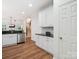 Open kitchen features white cabinets, granite countertops, and stainless steel appliances at 2656 Polo Club Blvd, Matthews, NC 28105