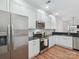 Bright kitchen featuring white cabinets, granite countertops, stainless steel appliances and a subway tile backsplash at 2656 Polo Club Blvd, Matthews, NC 28105