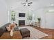 Bright living room with fireplace, large windows, ceiling fan and hardwood floors at 2656 Polo Club Blvd, Matthews, NC 28105