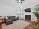 Inviting living room featuring hardwood floors, a fireplace, and plenty of natural light at 2656 Polo Club Blvd, Matthews, NC 28105