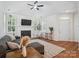 Bright living room with fireplace, large windows, ceiling fan and hardwood floors at 2656 Polo Club Blvd, Matthews, NC 28105