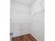 Bright walk-in closet with wood flooring and multiple shelving units at 2656 Polo Club Blvd, Matthews, NC 28105