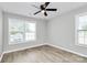 Bedroom with ample natural light, modern flooring and ceiling fan at 3853 Carl Parmer Dr, Harrisburg, NC 28075