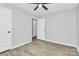 Spacious bedroom with light gray walls, wood floors, a ceiling fan, and ample lighting at 3853 Carl Parmer Dr, Harrisburg, NC 28075