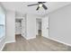 Bedroom with modern flooring, ceiling fan and adjacent bathroom at 3853 Carl Parmer Dr, Harrisburg, NC 28075