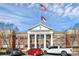 Harrisburg Town Hall, a stately building with American and North Carolina flags waving high at 3853 Carl Parmer Dr, Harrisburg, NC 28075