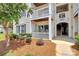 Condo entrance showcasing well-maintained landscaping, unit numbers, and architectural details at 3853 Carl Parmer Dr, Harrisburg, NC 28075