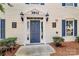 Inviting condo entryway featuring classic door, decorative sconces, and address markers at 3853 Carl Parmer Dr, Harrisburg, NC 28075