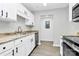 Charming kitchen featuring white cabinets, granite countertops, and modern stainless steel appliances at 3853 Carl Parmer Dr, Harrisburg, NC 28075