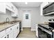 Inviting kitchen featuring white cabinets, granite countertops, and stainless steel appliances at 3853 Carl Parmer Dr, Harrisburg, NC 28075