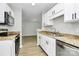 Bright kitchen with white cabinets, stainless steel appliances, and granite countertops at 3853 Carl Parmer Dr, Harrisburg, NC 28075