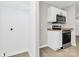 Bright kitchen space featuring white cabinets, granite countertops, and a pantry at 3853 Carl Parmer Dr, Harrisburg, NC 28075