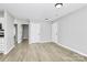 Bright living room with modern flooring, view of kitchen and multiple entries at 3853 Carl Parmer Dr, Harrisburg, NC 28075