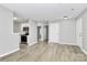 Bright living room featuring sleek flooring and modern white kitchen appliances at 3853 Carl Parmer Dr, Harrisburg, NC 28075