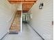 Exterior stairway leading to upper-level condos with wood steps and white railings at 3853 Carl Parmer Dr, Harrisburg, NC 28075