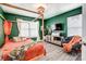 Bedroom with hardwood floors, comfortable seating, a four-poster bed and decorative green walls at 3925 Rothwood Ln, Harrisburg, NC 28075