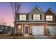 Charming townhome with brick accents, a one-car garage, and a welcoming front porch at 3925 Rothwood Ln, Harrisburg, NC 28075