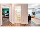 Hallway with hardwood floors providing entrances to bathroom, bedroom, and office space at 3925 Rothwood Ln, Harrisburg, NC 28075