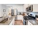 Well-lit kitchen with stainless steel appliances, granite countertops, and ample storage space at 3925 Rothwood Ln, Harrisburg, NC 28075