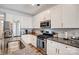 Updated kitchen with granite countertops, stainless steel appliances, and white cabinetry at 3925 Rothwood Ln, Harrisburg, NC 28075