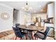 Kitchen with island, stainless steel appliances and adjacent dining area under modern lighting at 3925 Rothwood Ln, Harrisburg, NC 28075
