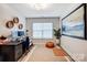 Modern office with a desk, chair, computer, and artwork on the painted walls at 3925 Rothwood Ln, Harrisburg, NC 28075