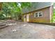 View of the backyard featuring a concrete patio and a house with brick facade and a door at 5008 Brooktree Dr, Charlotte, NC 28208