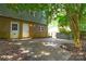 View of a backyard with patio leading to a brick and siding house with two entrances and a fenced border at 5008 Brooktree Dr, Charlotte, NC 28208