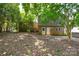 View of the house with a backyard featuring lush greenery and mature trees at 5008 Brooktree Dr, Charlotte, NC 28208