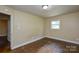 This bedroom boasts hardwood floors, a window, and neutral wall paint at 5008 Brooktree Dr, Charlotte, NC 28208
