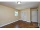 A bedroom featuring wood floors, closet, and natural light from a window at 5008 Brooktree Dr, Charlotte, NC 28208