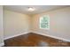 Simple bedroom with hardwood floors and a window at 5008 Brooktree Dr, Charlotte, NC 28208
