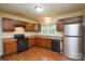 Kitchen featuring wood cabinets, stainless steel refrigerator, and modern appliances at 5008 Brooktree Dr, Charlotte, NC 28208