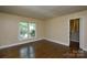 A bright living room with hardwood floors and a large window offering natural light at 5008 Brooktree Dr, Charlotte, NC 28208
