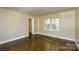 Living room with hardwood floors and a window offering natural light at 5008 Brooktree Dr, Charlotte, NC 28208
