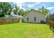 A spacious, green lawn offers ample room for outdoor activities and relaxation in a fenced backyard at 551 Sylvan Sw St, Concord, NC 28025