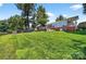 Expansive backyard with lush green lawn and lake views and the patio outside the back of the house at 622 S Carolina Ave, Statesville, NC 28677