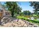 Lakeside backyard with stone patio, wooden dock, and fire pit, ideal for outdoor relaxation and recreation at 622 S Carolina Ave, Statesville, NC 28677