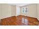 This bedroom features hardwood floors, a closet, and large window with neutral walls at 622 S Carolina Ave, Statesville, NC 28677