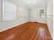 Bright bedroom with wood floors, two windows, and an open closet, providing ample natural light at 622 S Carolina Ave, Statesville, NC 28677
