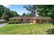 Charming single-story brick home with manicured lawn and mature trees in a desirable neighborhood at 622 S Carolina Ave, Statesville, NC 28677