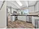 This bright kitchen features stainless steel appliances, gray cabinets, and hardwood floors at 622 S Carolina Ave, Statesville, NC 28677