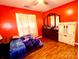 Cozy bedroom with vibrant walls, ceiling fan, closet, and wood-look floors at 7333 Rosehall Dr, Charlotte, NC 28227