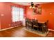 Comfortable dining area with a ceiling fan and a bright window with patterned curtains at 7333 Rosehall Dr, Charlotte, NC 28227