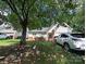 Charming single-Gathering home with a well-maintained lawn, cozy front porch, and ample parking at 7333 Rosehall Dr, Charlotte, NC 28227