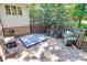 Back deck featuring hot tub, grill and outdoor seating surrounded by lush greenery at 8500 Peyton Randolph Dr, Charlotte, NC 28277